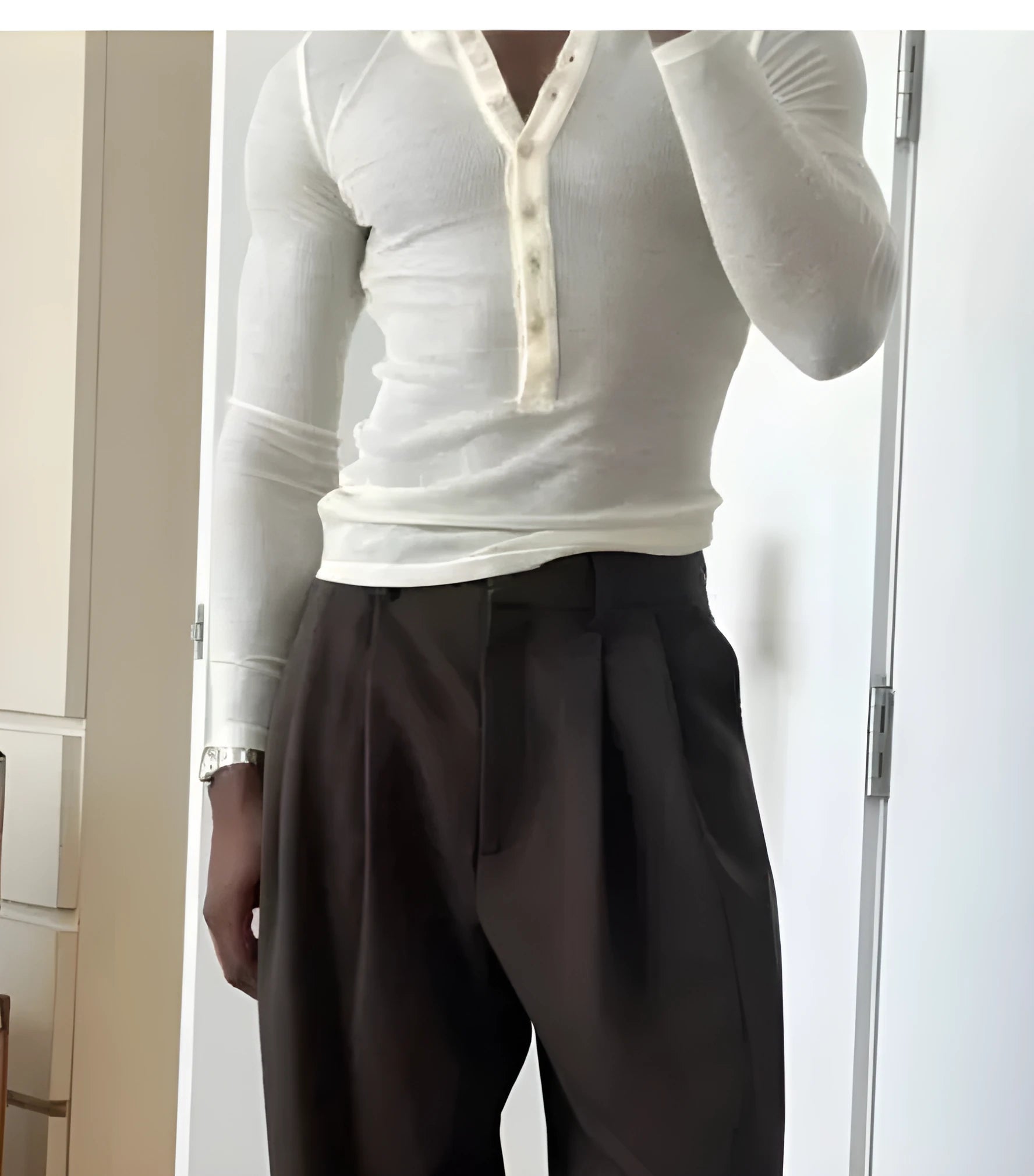 Men's cream coloured ribbed long-sleeve henley top with button placket.