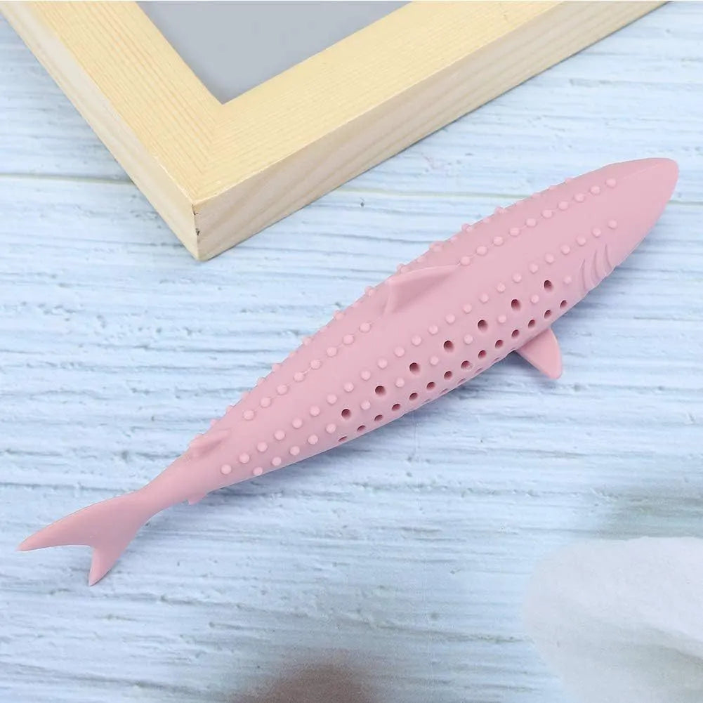 Green silicone dolphin-shaped cat chew toy on a white background, showing side air holes.