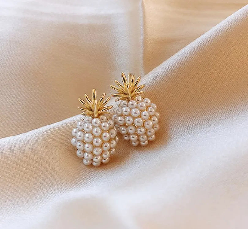 Women's gold electroplated alloy drop earrings with pineapple design and starfish pearl, featuring inlaid stones.
