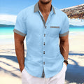 Man wearing a striped, slim fit, pure cotton short sleeve shirt with a double button front in a light blue colour.