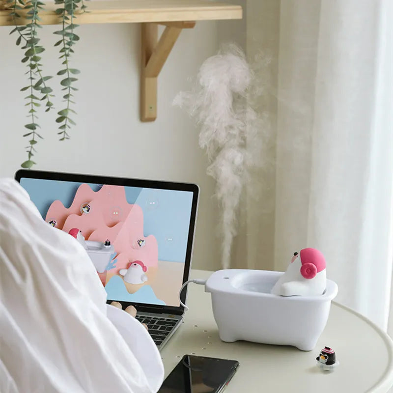 White USB-powered portable air humidifier and essential oil diffuser on a desk