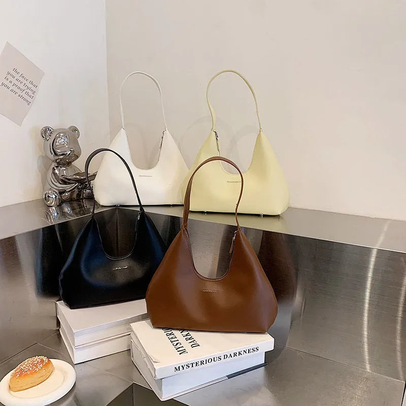 Brown retro PU leather shoulder handbag with a single strap and pillow-shaped design on a plain background.
