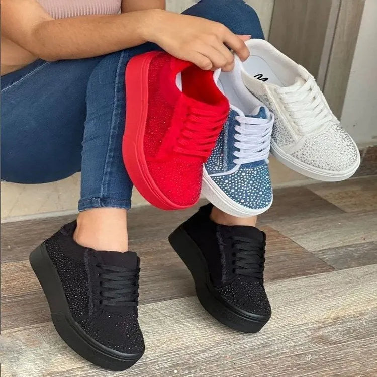 Women's black casual sneakers with rhinestone lace-up detail and a thick flat rubber sole.