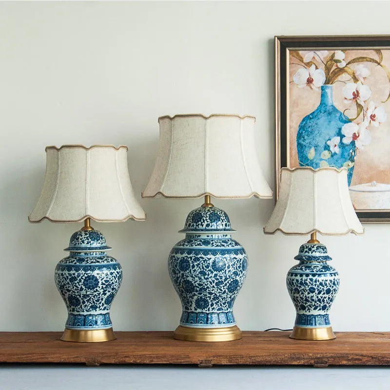 Chinese style blue and white porcelain table lamp with handmade ceramic base and cloth shade on bedside table