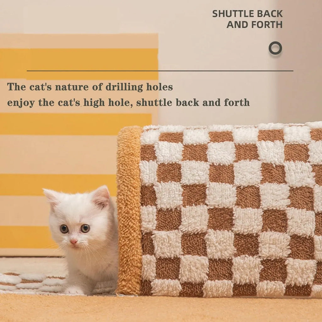 Brown plaid plush cat tunnel bed with a zippered entrance and central mat on a wooden floor.