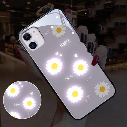 Luminous white daisy design iPhone case with voice-activated colour lights on a phone