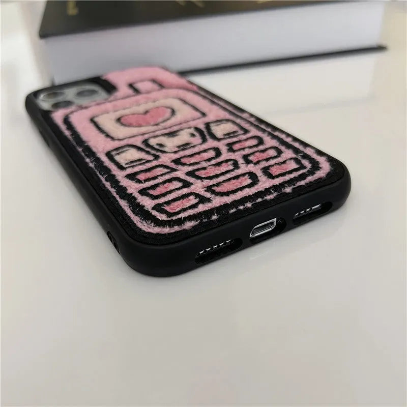 Pink TPU iPhone case with a textured towel-embroidered back cover, shown fitting an iPhone.