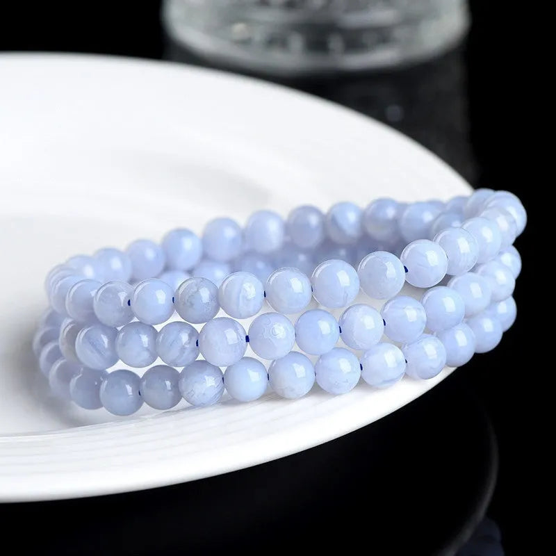 Blue agate bracelet with patterned ball and striped scattered beads showing three-circle construction