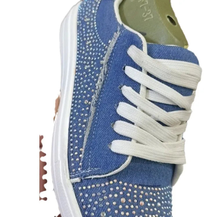 Women's black casual sneakers with rhinestone lace-up detail and a thick flat rubber sole.