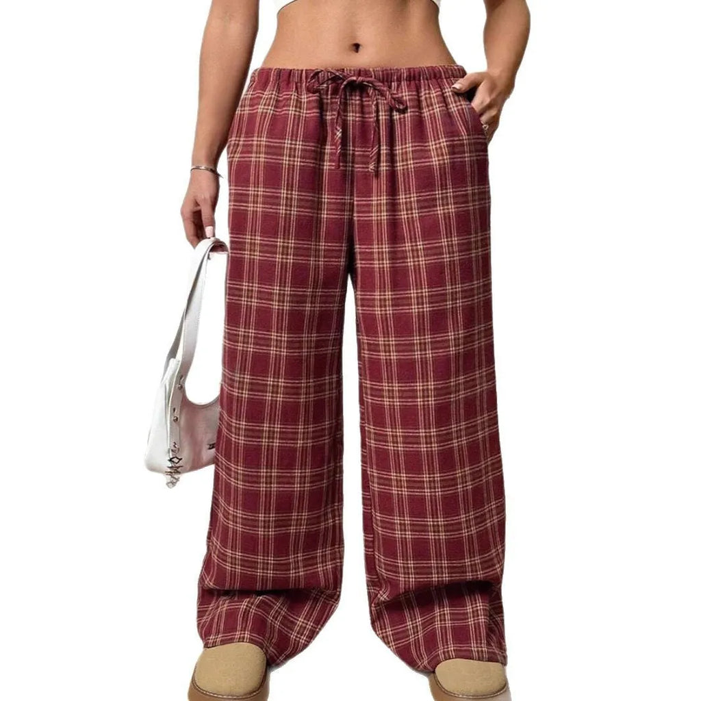 Women's red loose fit casual trousers with drawstring waist and plaid pockets, laid flat.