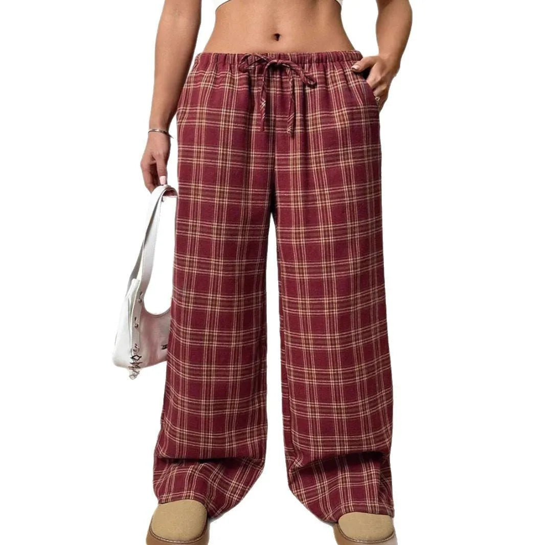 Women's red loose fit casual trousers with drawstring waist and plaid pockets, laid flat.