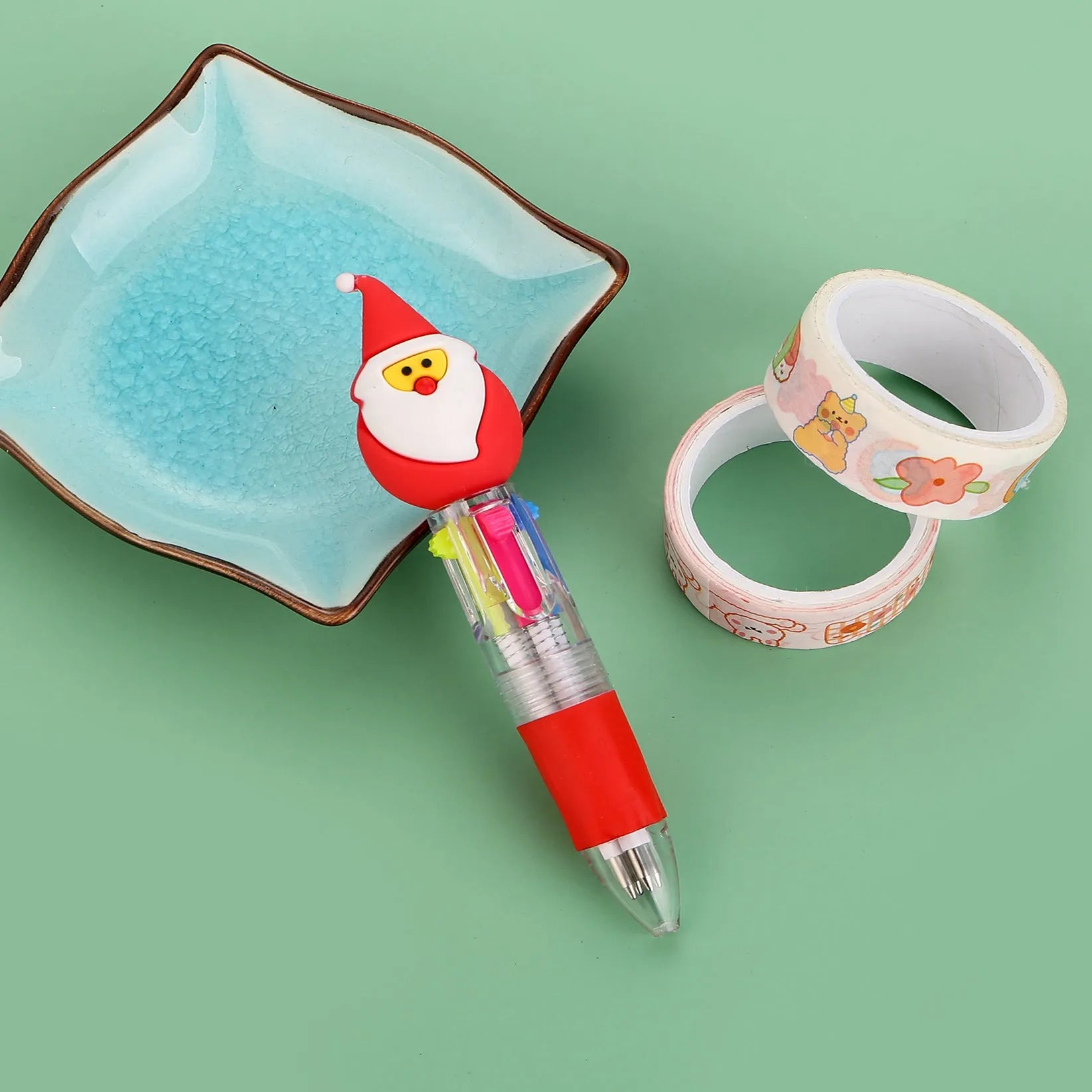 Christmas mini four-colour press-action ballpoint pen with festive designs measuring 11 cm.