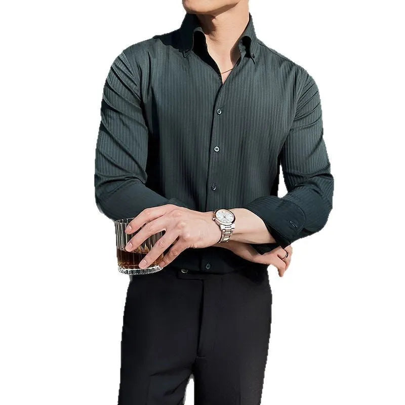 Man wearing a dark striped long sleeve V-neck cardigan shirt in a casual setting.