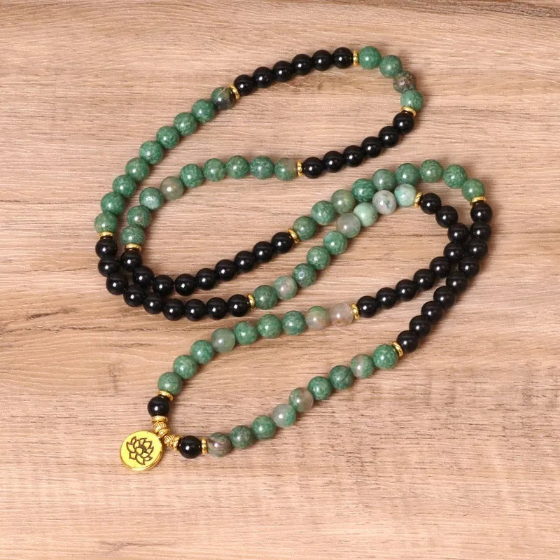 Green and black elastic beaded bracelet with alloy construction for women's wrist jewellery