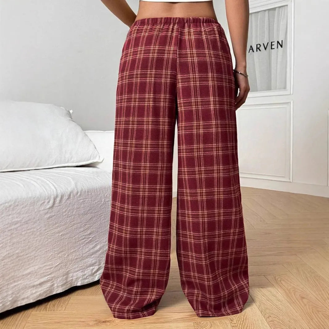 Women's red loose fit casual trousers with drawstring waist and plaid pockets, laid flat.