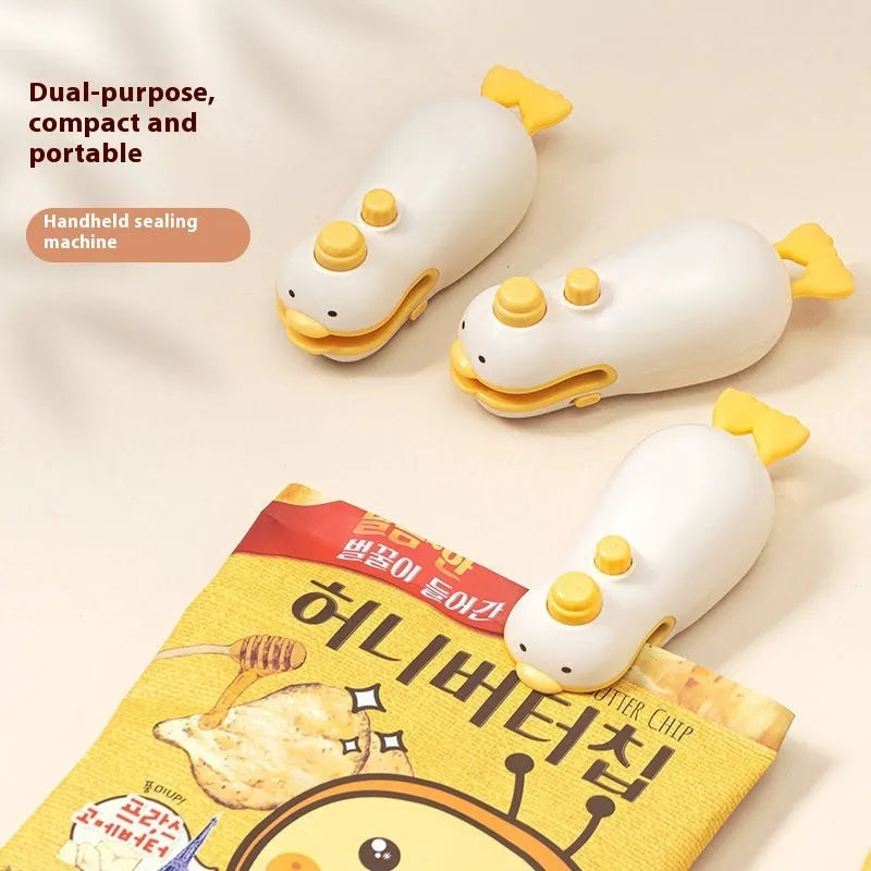 Small yellow duck animal jacquard style rechargeable handheld plastic bag sealing machine with charging cable.