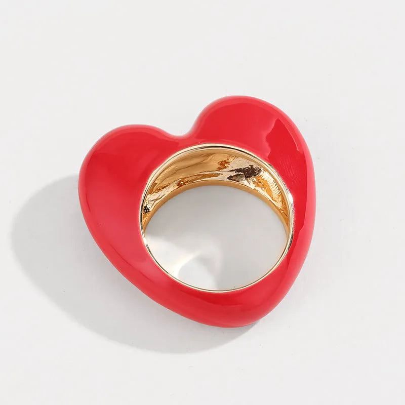 Three-dimensional heart-shaped enamel ring in zinc alloy, shown in choice of colours.