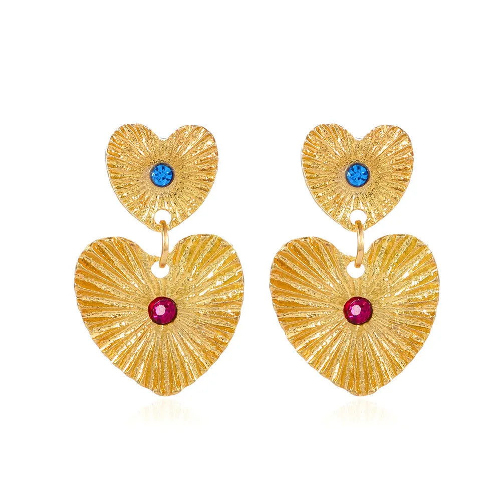 Alloy bohemian sunflower heart-shaped earrings with rhinestones in gold finish on white background