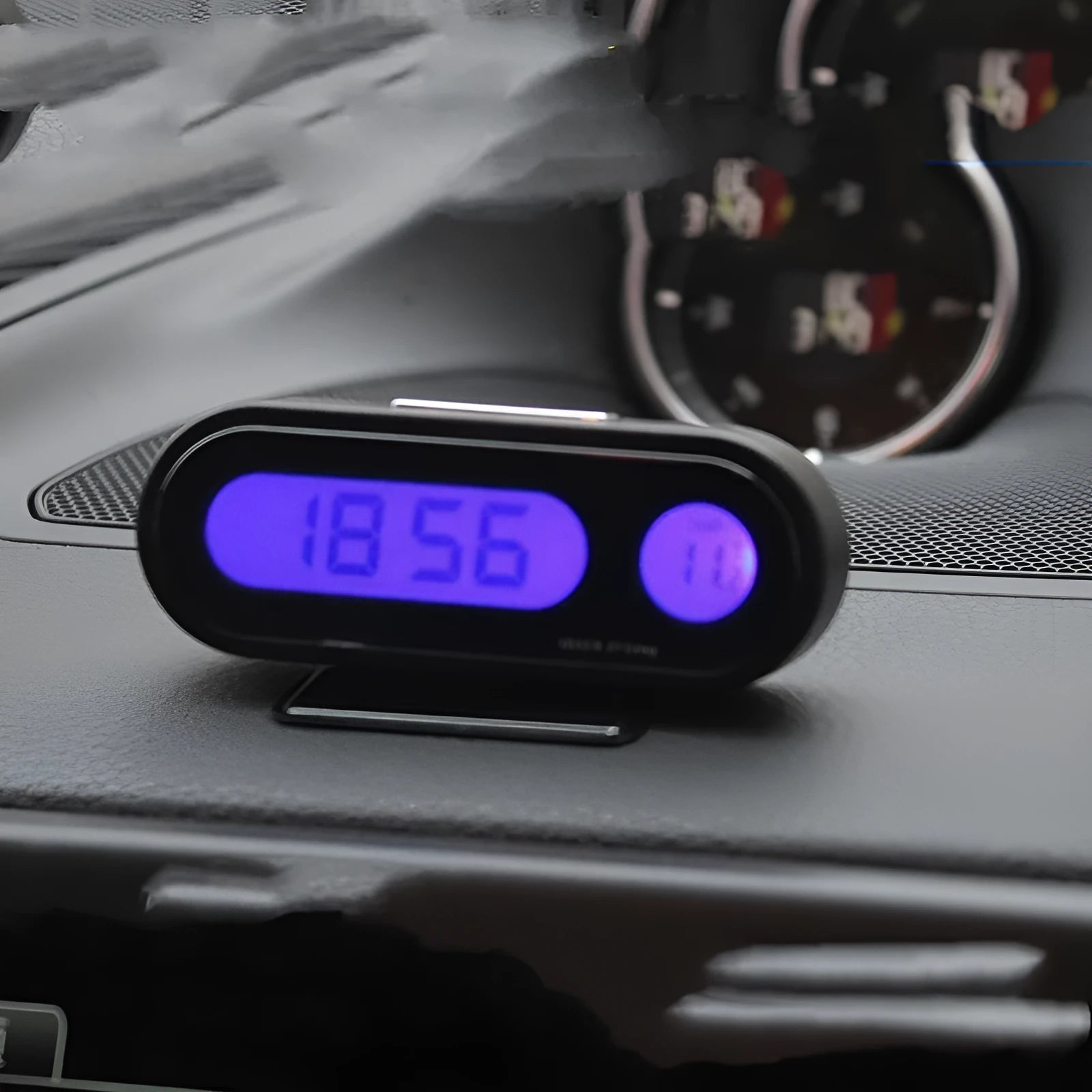 Black car clock thermometer with luminous LED display showing time and temperature on adjustable dashboard bracket