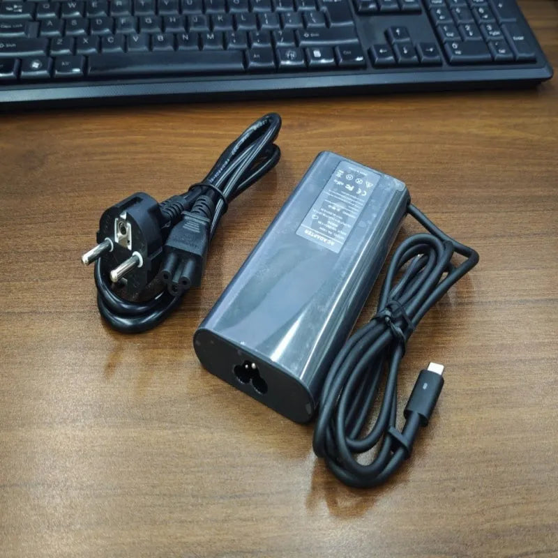 Black oval 65W Type-C laptop power adapter with international power cords