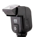 SLR camera flash unit with adjustable tilt head mounted on camera hot shoe