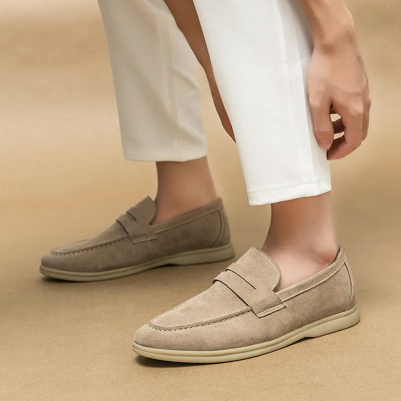 Men's black leather slip-on casual shoes with a round toe and mid-height heel on a rubber sole.