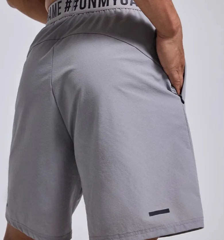 Men's loose fit black sports shorts with an elastic waistband, shown from the front.