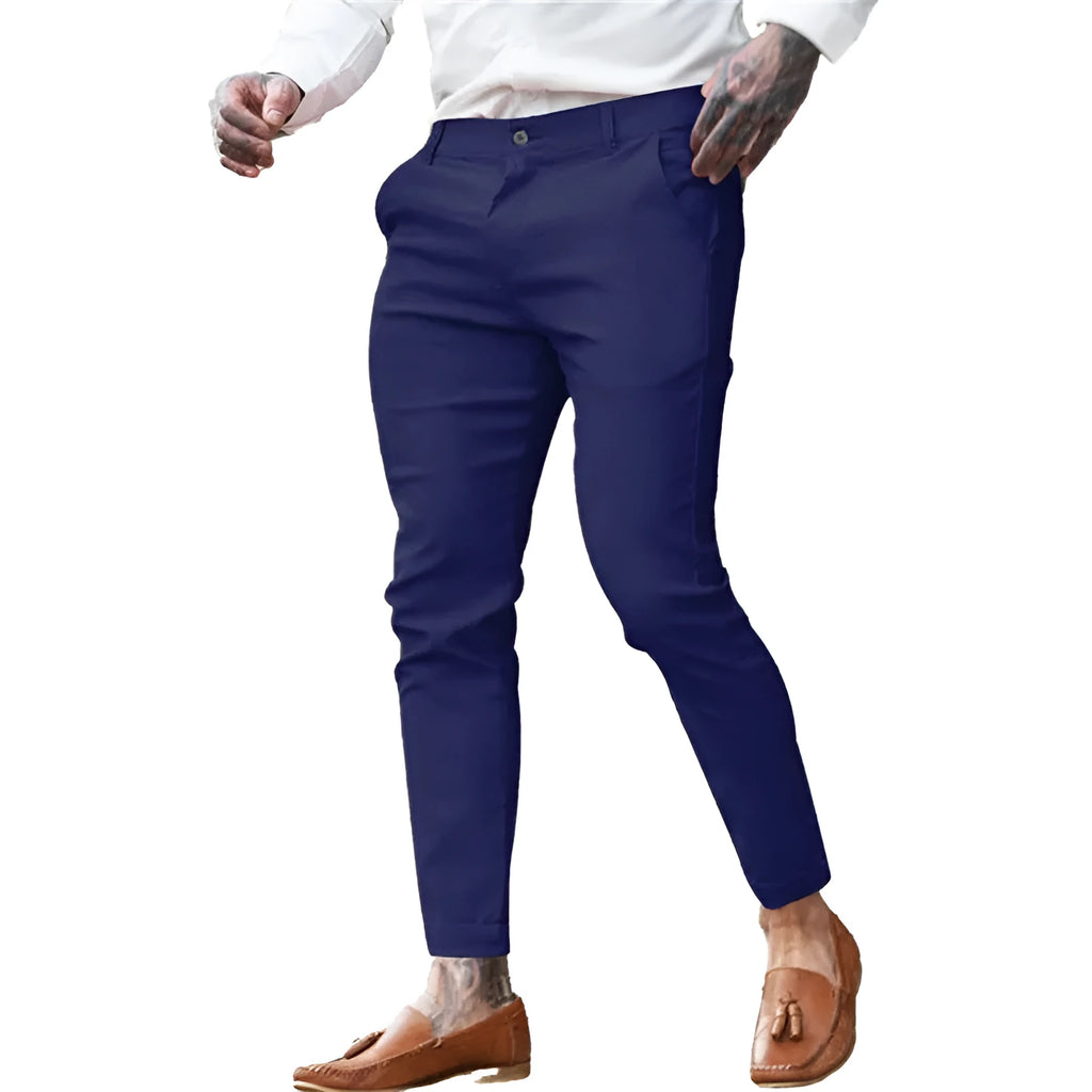 Men's slim fit stretch cotton twill pencil trousers on a hanger, shown in apricot colour.