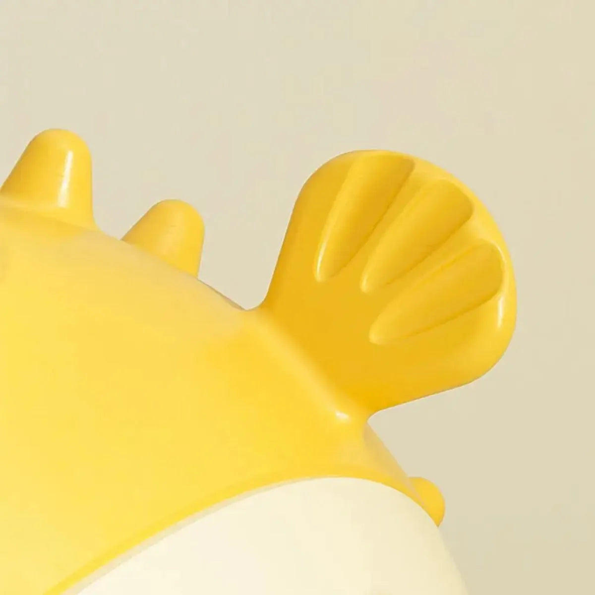 Yellow fish-shaped durable vinyl dog chew toy with textured surface for teeth cleaning.