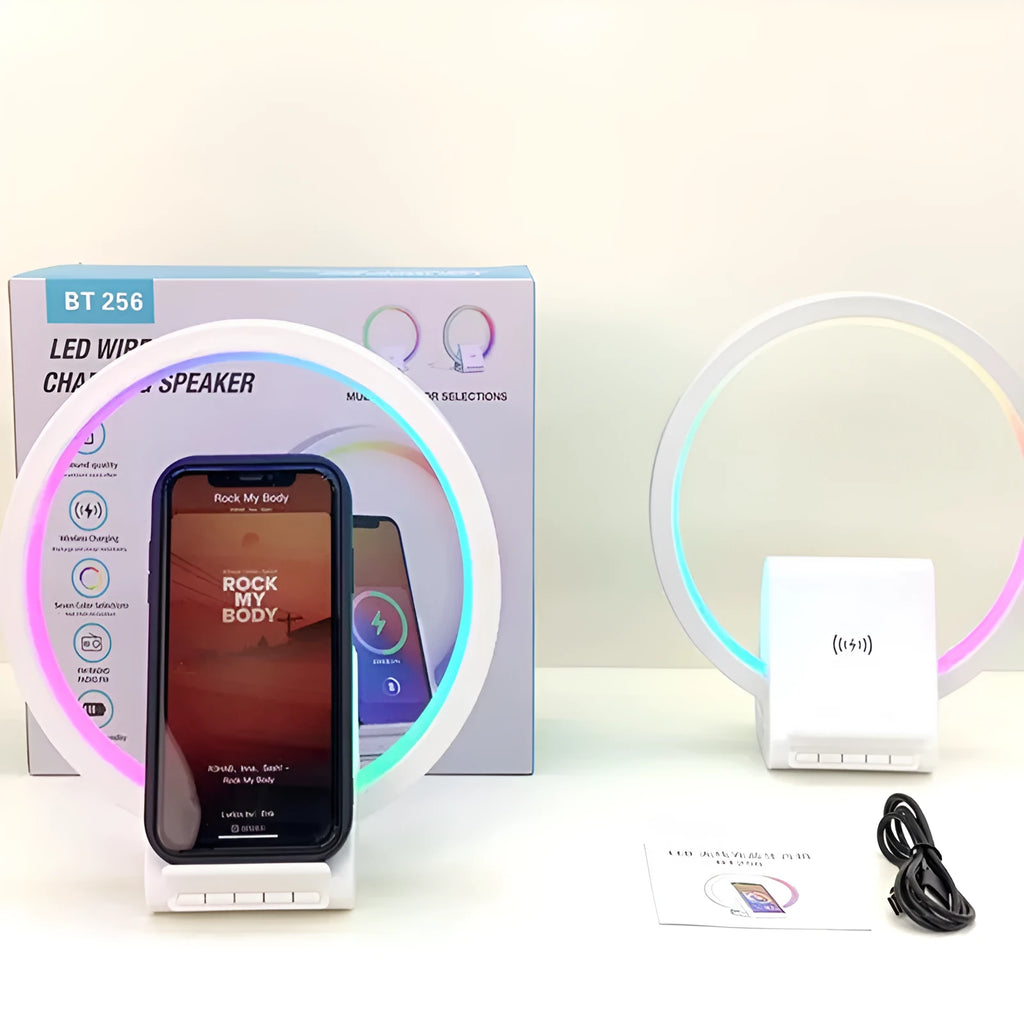 White circular smart Bluetooth speaker with ambient lighting and wireless charging pad