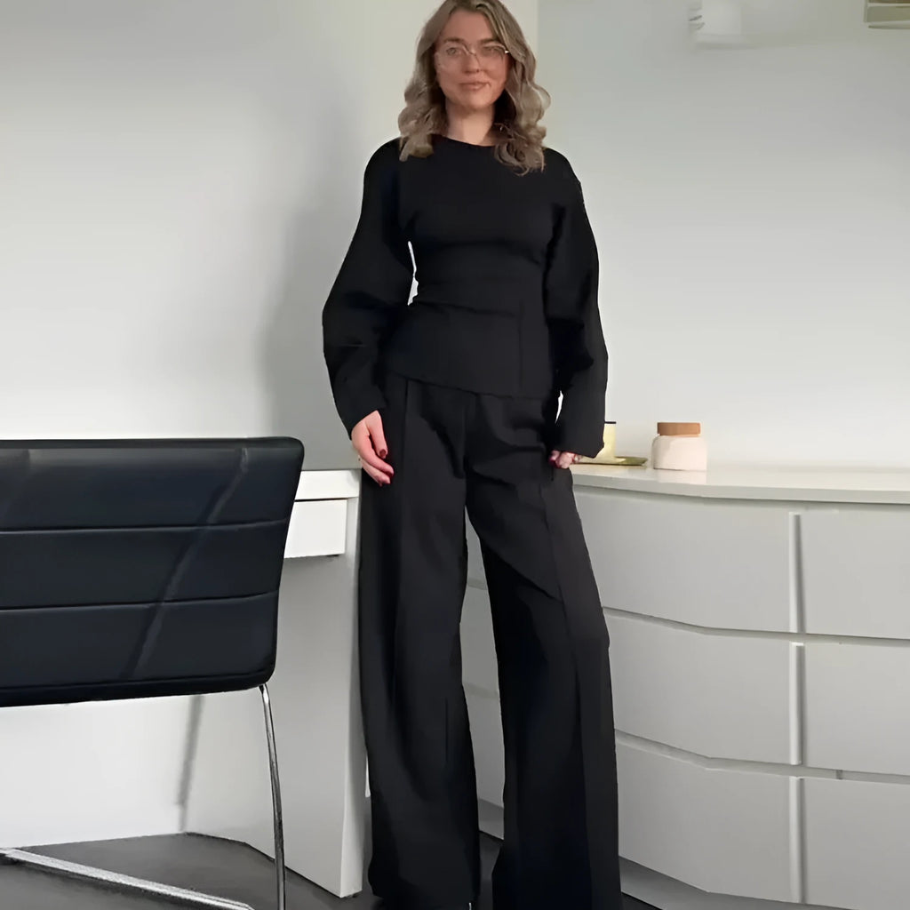 Women's black polar fleece suit set with long sleeve O-neck top and wide leg trousers.