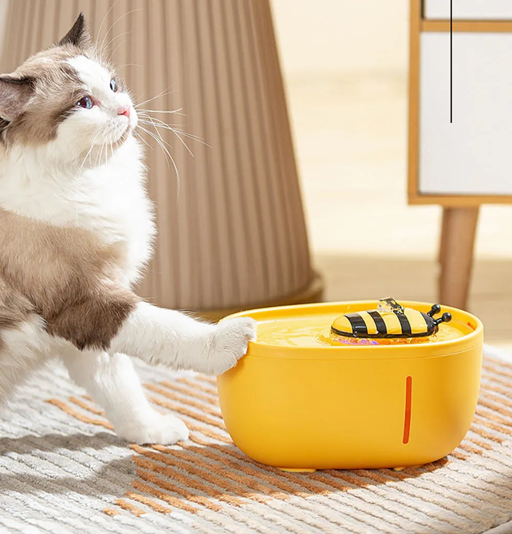 Yellow USB-powered cat water fountain with filter on anti-slip base.