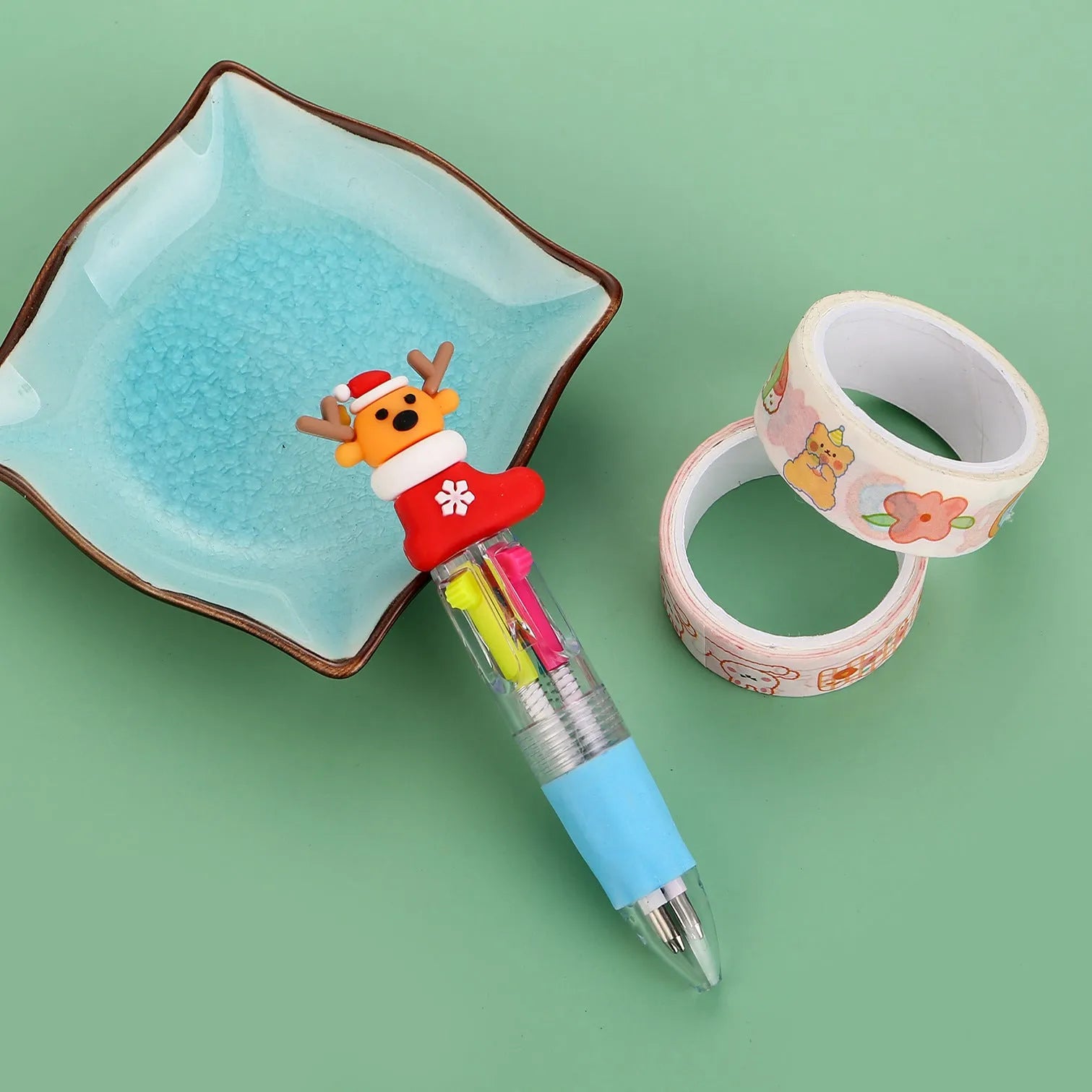 Christmas mini four-colour press-action ballpoint pen with festive designs measuring 11 cm.
