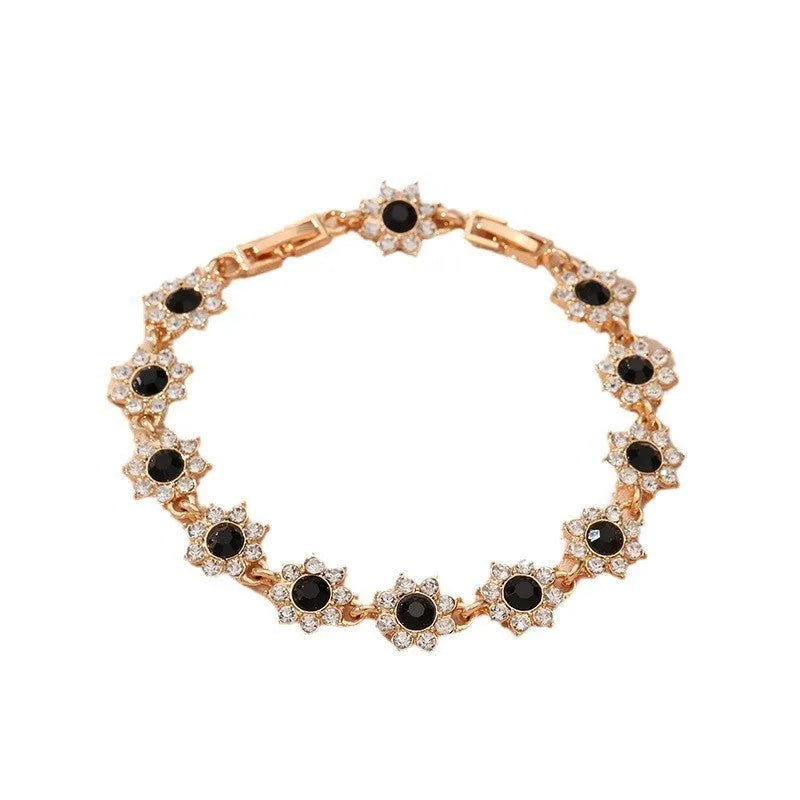 Close-up of a floral-shaped zinc alloy bracelet with an electroplated finish and crystal details.