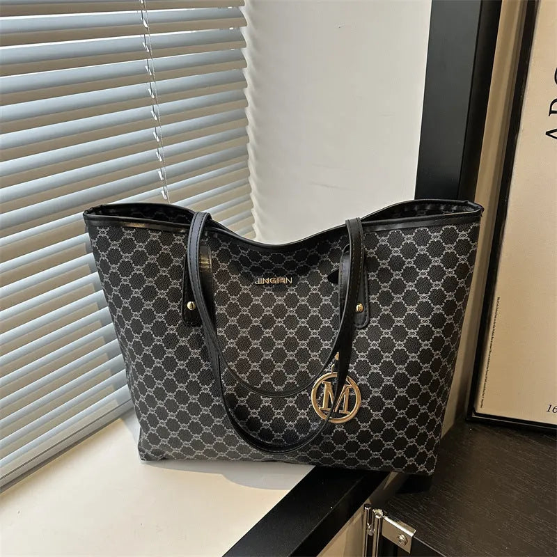 Structured black PU leather shoulder bag with adjustable strap and visible sewing thread detailing