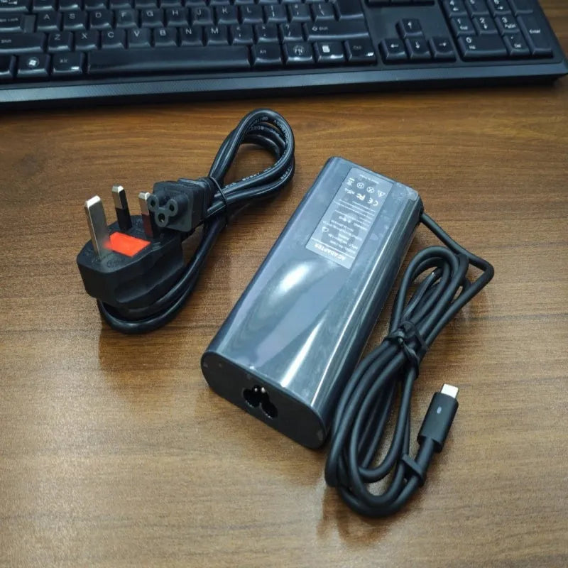 Black oval 65W Type-C laptop power adapter with international power cords