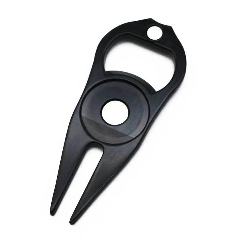 Black zinc alloy golf ball yoke and bottle opener tool with 25mm coin on putting green