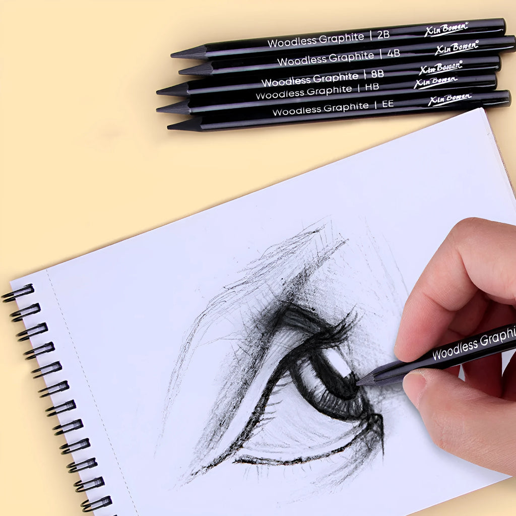 Six wood-free graphite sketching pencils showing different darkness grades from HB to EE