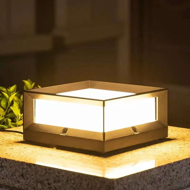 Aluminium outdoor solar column light with LED, shown in garden setting.