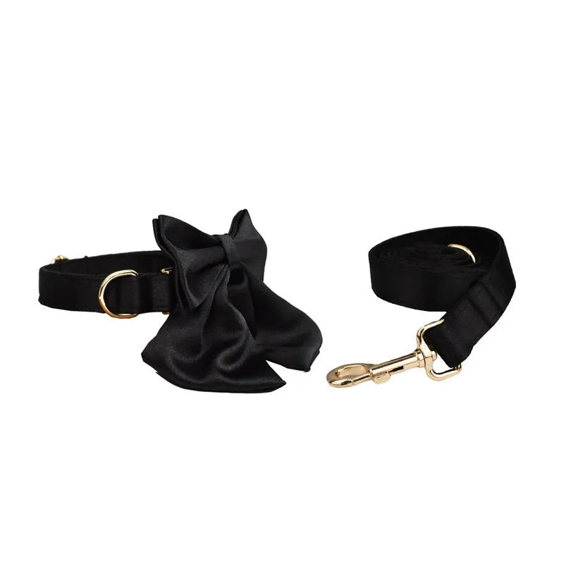 Complete dog accessory set showing collar, leash, bow and vest in cloth material