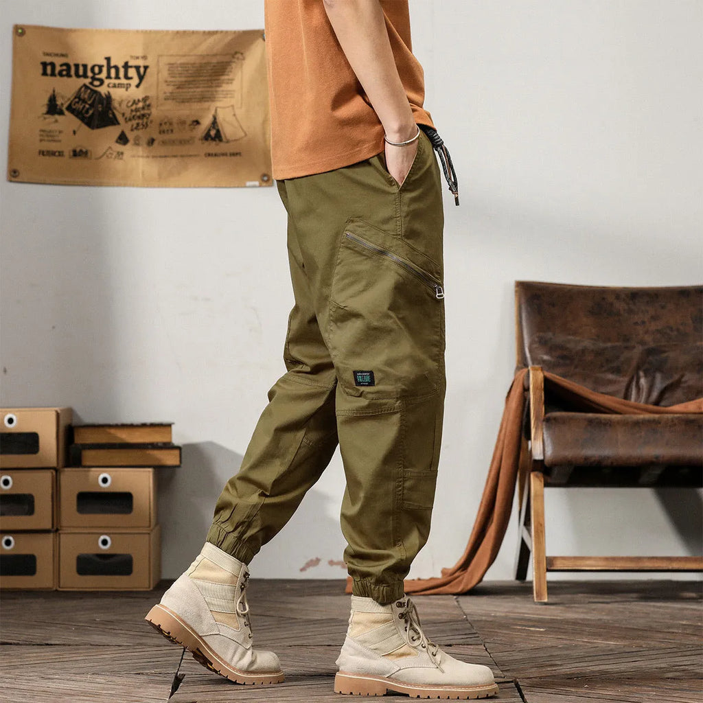 Men's cotton harem pants with ankle banded legs in khaki colour showing zip placket fly detail