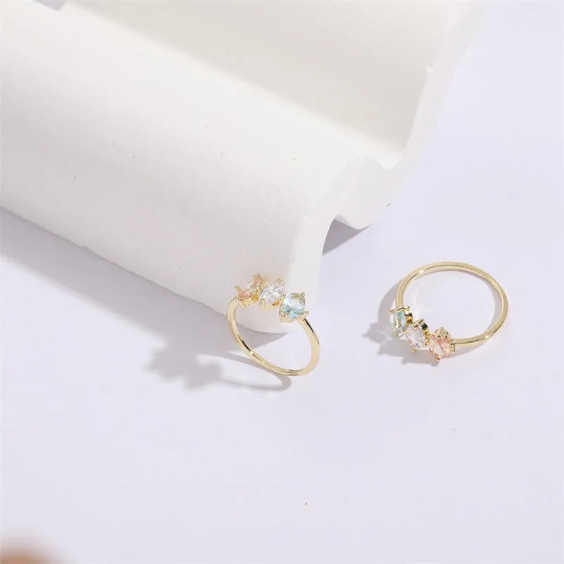 Geometric triangular copper women's ring with tricolour zircon stones and electroplated gold colour finish