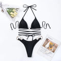Black women's bikini swimsuit with a long strap and metal ring, showing backless design and split-style briefs.