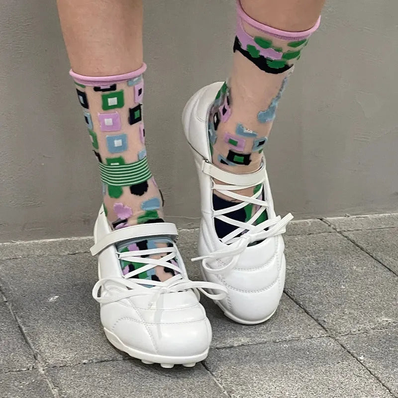 Women's silver lace-up bow sports shoes with a round toe and mid heel on a white background.