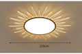 Modern round aluminium ceiling lamp with LED light source on a white ceiling.