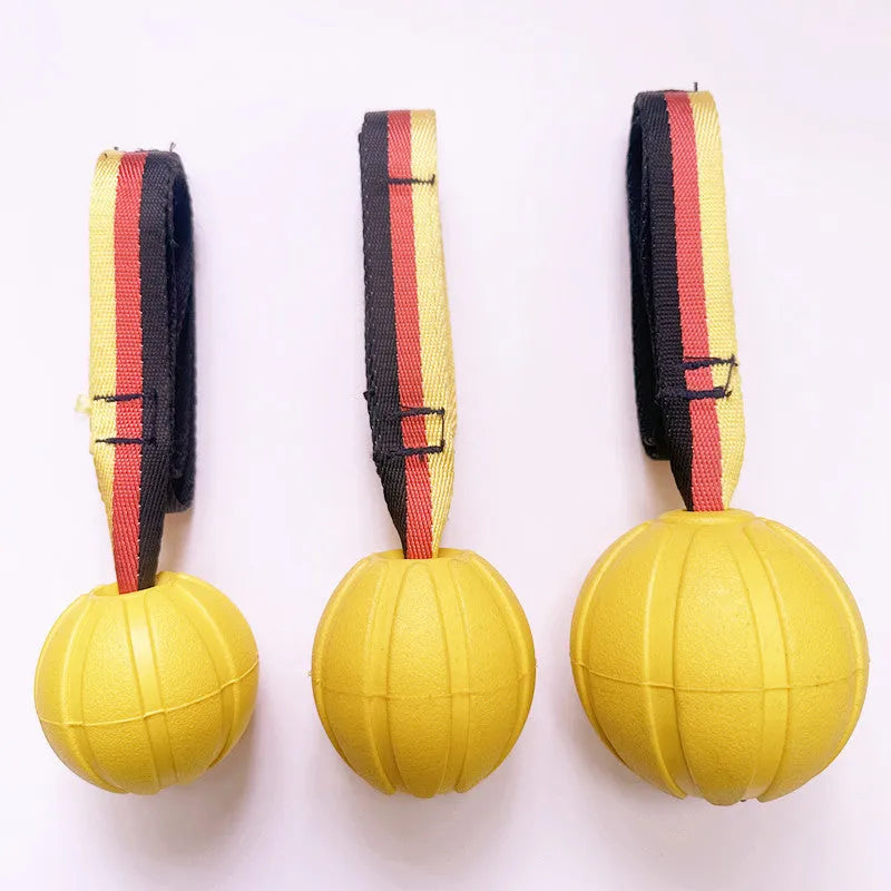 EVA floating dog training ball in camouflage colour and yellow, shown in 65mm, 7cm, and 9cm diameter sizes.