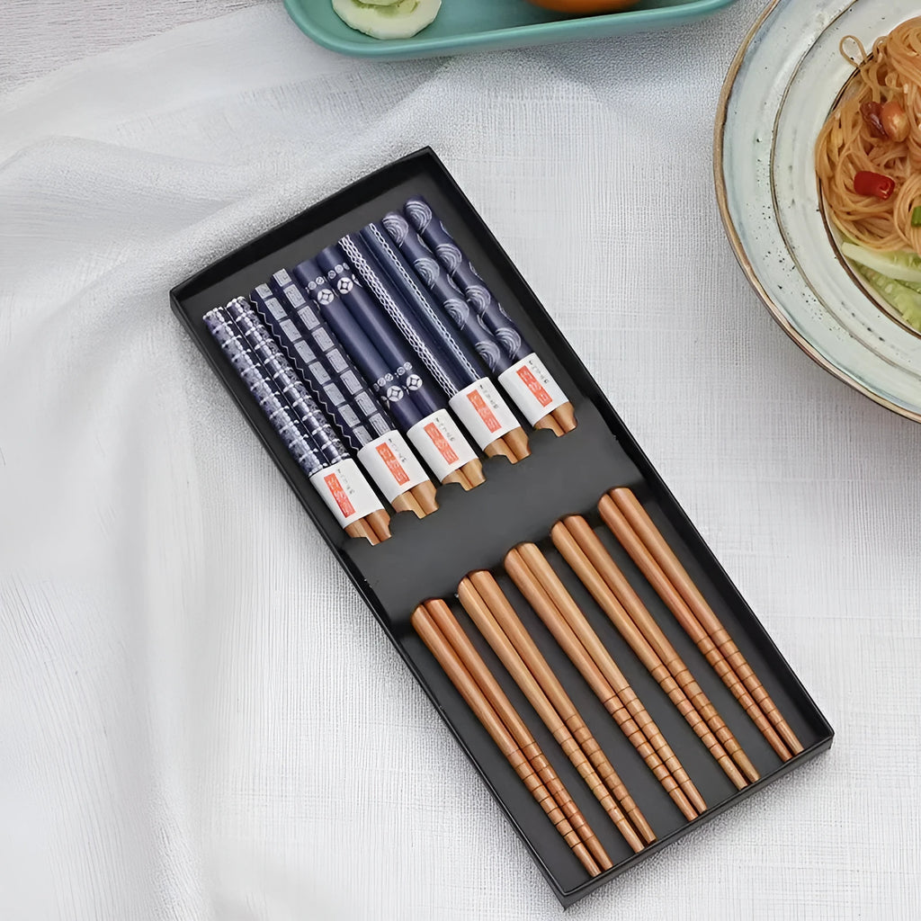 Set of bamboo chopsticks with Japanese lucky cat and elegant blue patterns in gift box or simple packaging.