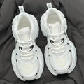 Beige women's mesh platform sports shoes with a wedge heel and lace-up front.