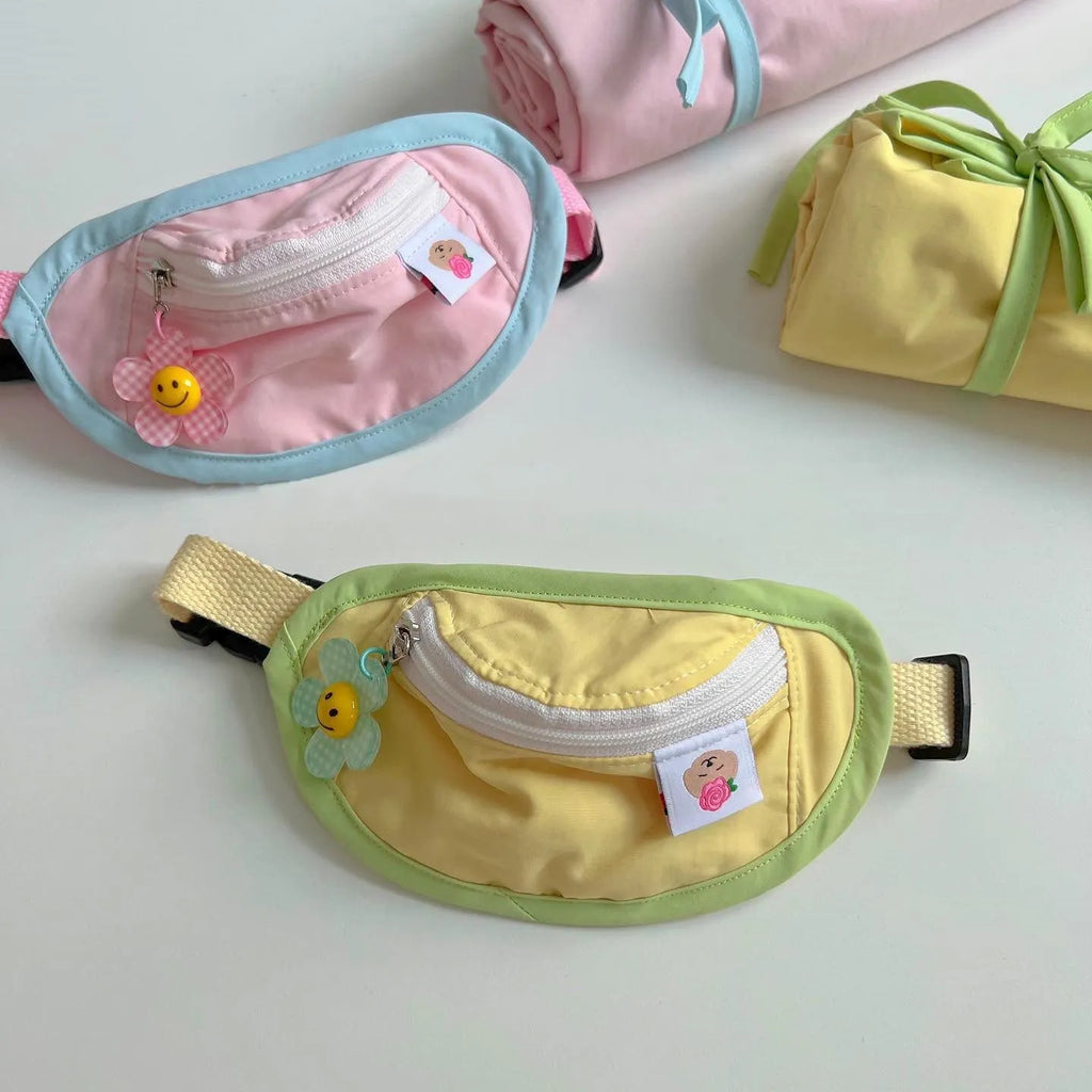 Powder blue, yellow, green, and pink backpack-style carrier for small dogs and cats on a white background.