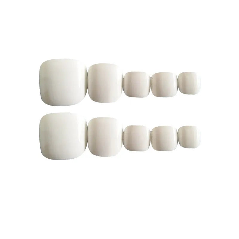 Set of white false nails with a starry sky pattern design, laid out for press-on application.